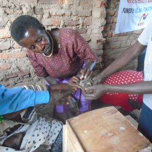 During training one of the women being shown how to identify a male and female quail