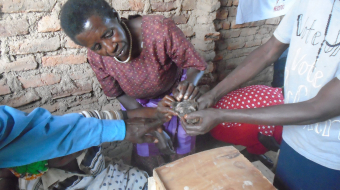 During training one of the women being shown how to identify a male and female quail