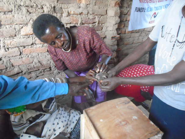 During training one of the women being shown how to identify a male and female quail